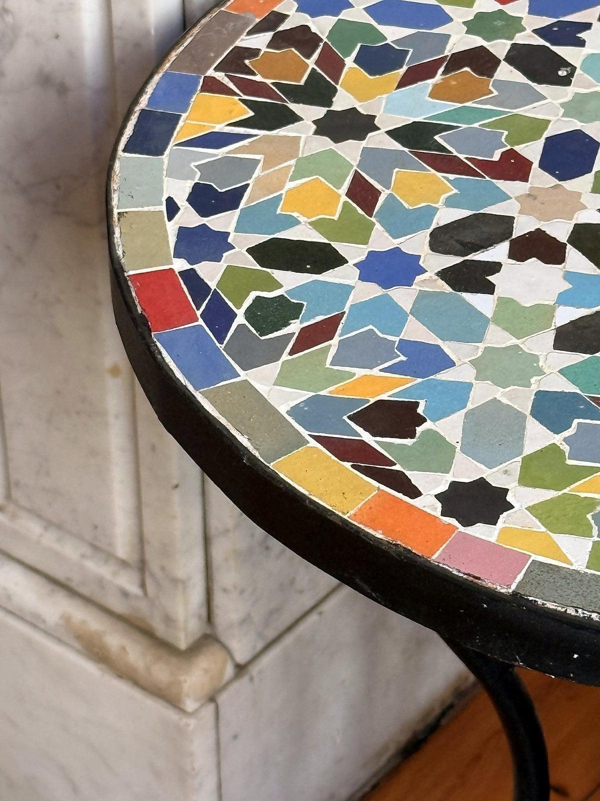 Close view of the Bahja zellige top, hand-cut glazed tiles set in cement with a matte black steel rim