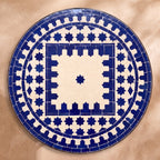 Bhar zellige tabletop seen from above, Salé friezes and star ring in navy on cream