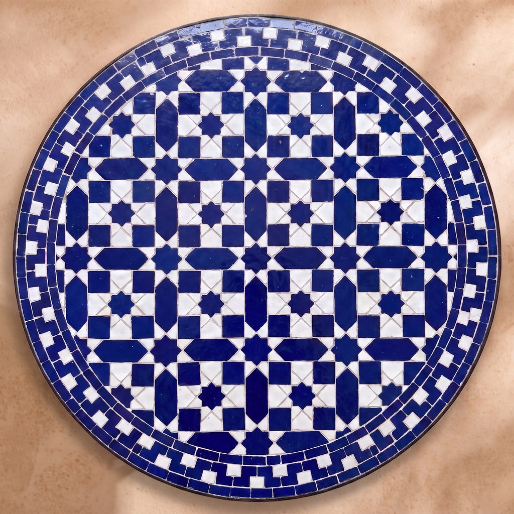 Fassia zellige tabletop seen from above, cobalt eight-point star lattice with a stepped border on white, inspired by Fez embroidery