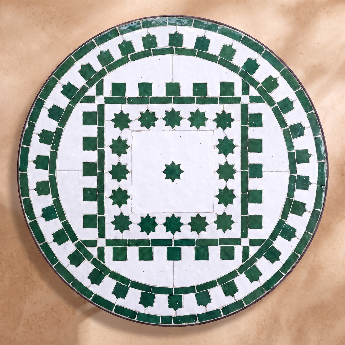Ghaba zellige tabletop seen from above, Salé friezes and star ring in green on white