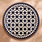 Hbar zellige tabletop seen from above, Fez star lattice in black on cream