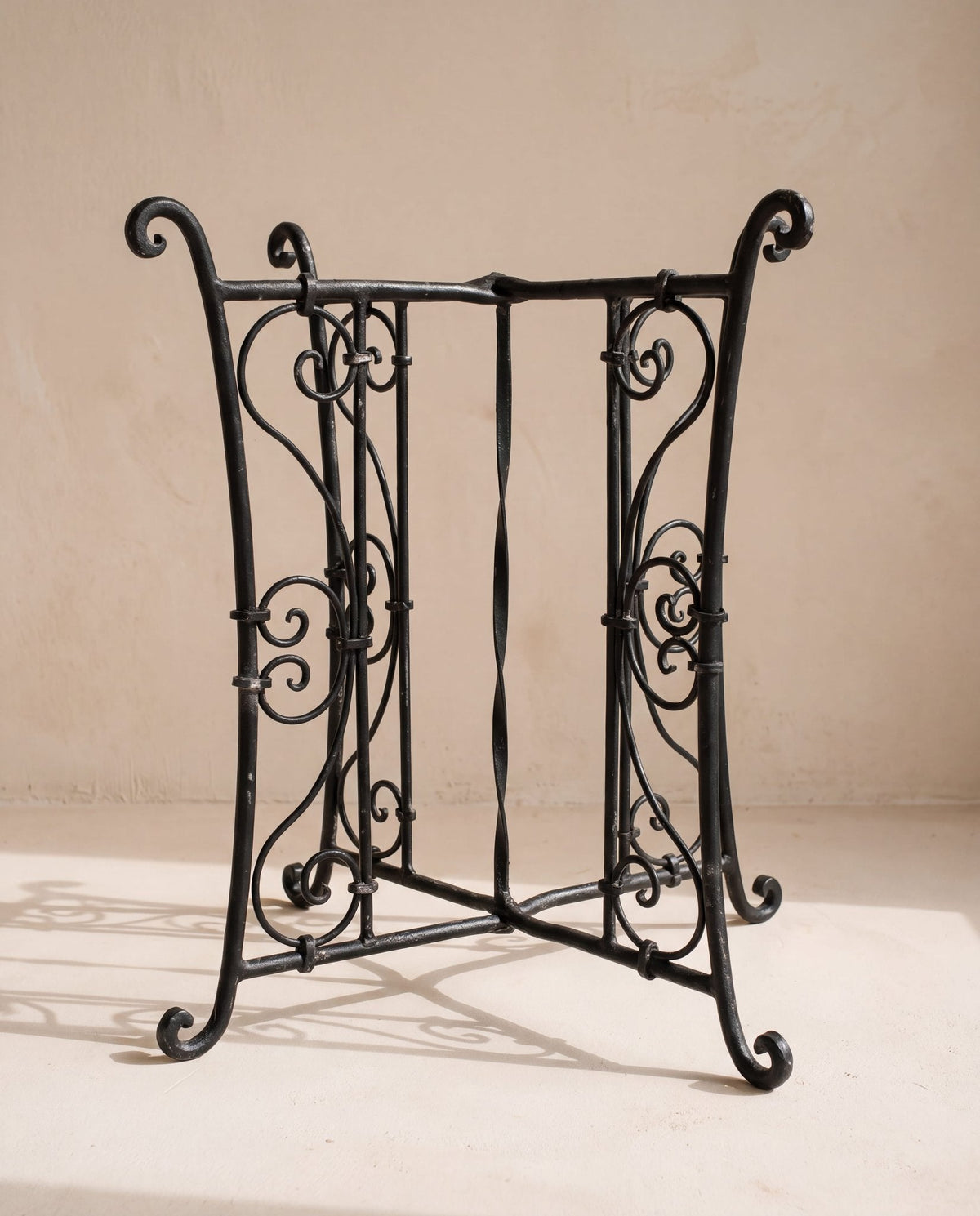 The ornamented wrought iron base option, hand-forged scrollwork on the lower part, painted matte black, +€25 on Ø50 and Ø60 at 55 cm.