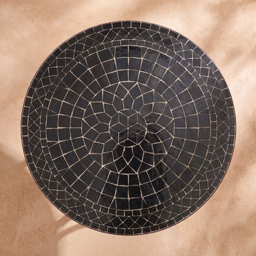 Kahla zellige mosaic side table seen from above, concentric rings of glossy black hand-cut tiles with pale joints, colour rendering of the design