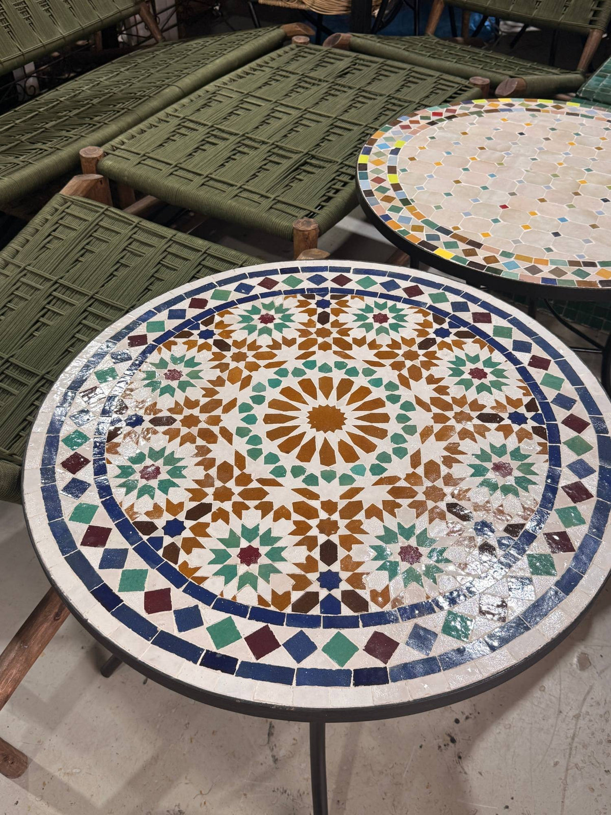 Close view of the Kawkab zellige top, hand-cut green, navy and burgundy pieces