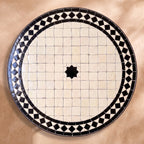 Nila zellige tabletop seen from above, Fez stepped border and centre star in black diamond border on white