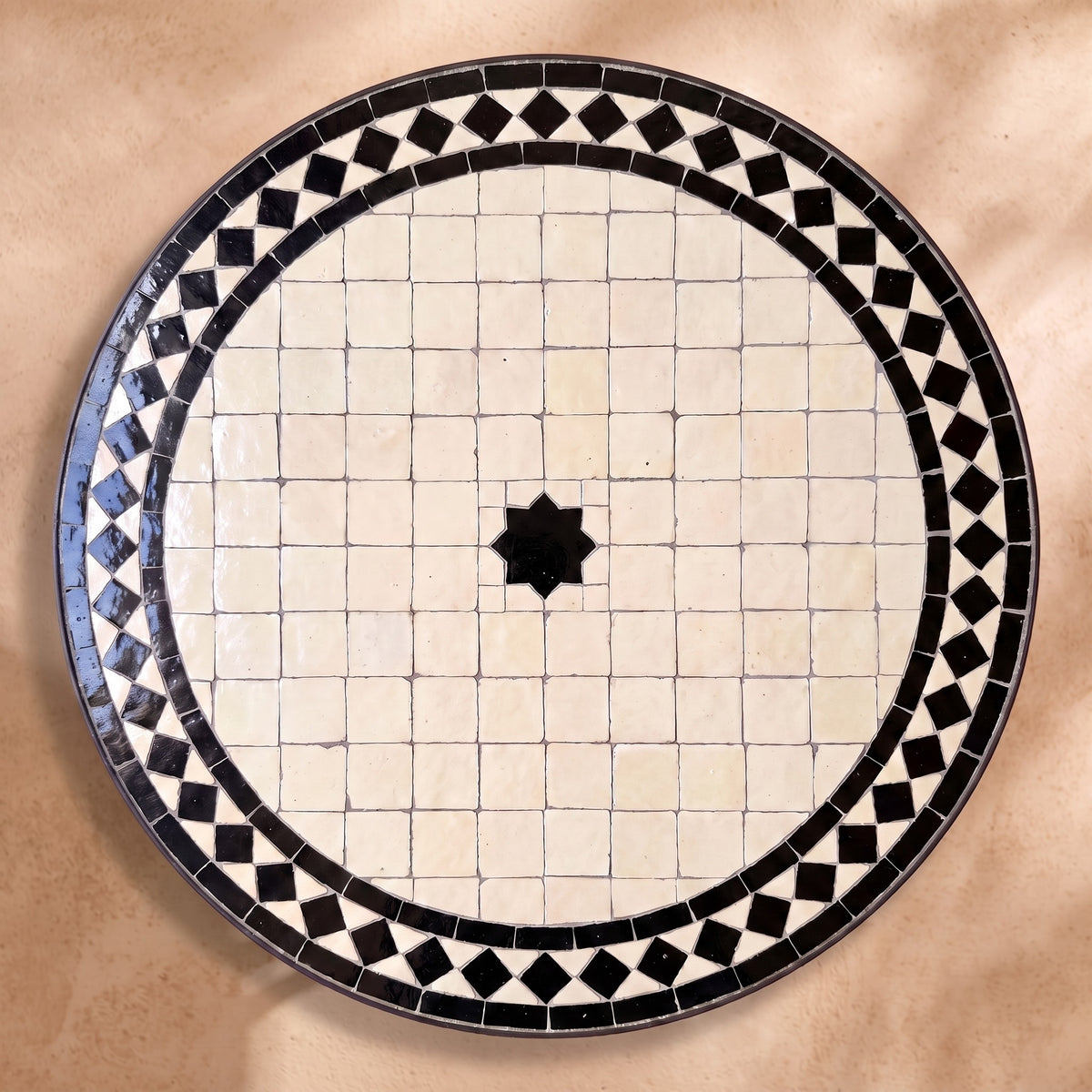 Nila zellige tabletop seen from above, Fez stepped border and centre star in black diamond border on white