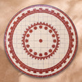 Slawiya zellige tabletop seen from above, brick-red merlon friezes around a star ring on white, inspired by Salé embroidery