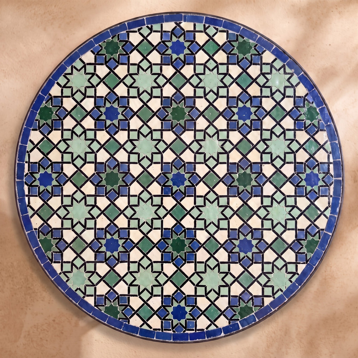 Sma zellige tabletop seen from above, Meknès outlined stars in cool blues and light green with black outlines