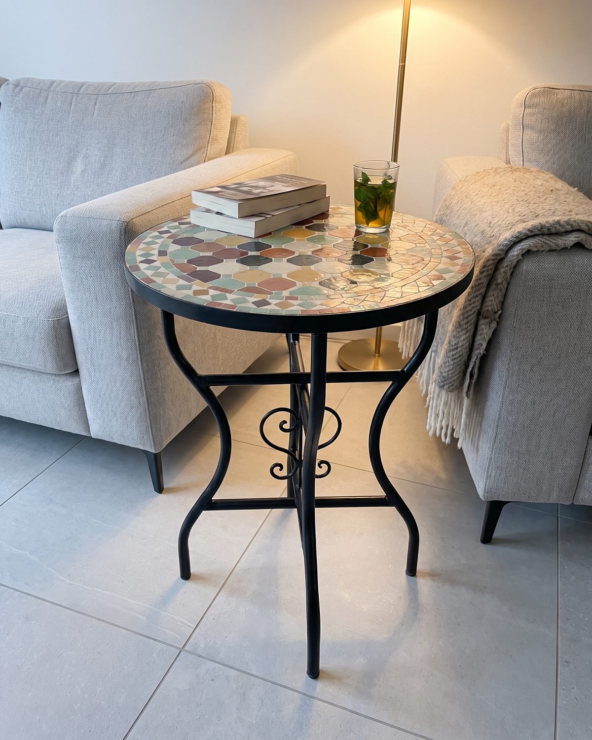 Khrif zellige table shown on light grey tiles. Styling image: a colour rendering of the design placed in a room, not a photograph of a finished table.