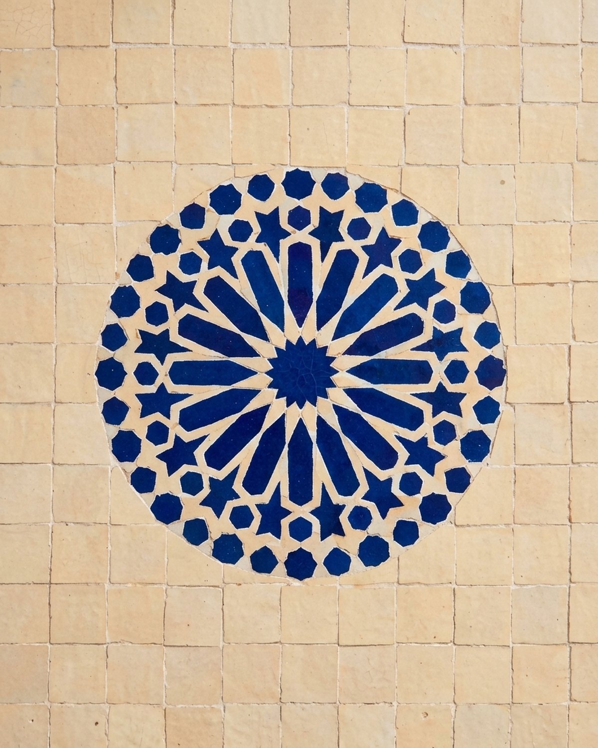 Taj zellige table shown on medaillons in fès-blau. Styling image: a colour rendering of the design placed in a room, not a photograph of a finished table.